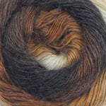 A close-up of a wound skein of variegated yarn in dark brown, black, and warm tan tones with a small white section.