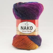 A skein of Nako Arya Eirnd yarn with a multicolor gradient transitioning from purple and blue at the top to orange and yellow at the bottom, wrapped with a red and beige paper label.