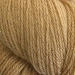 Close-up of a skein of soft, fuzzy yarn in a warm sandy beige color with subtle glittering flecks.