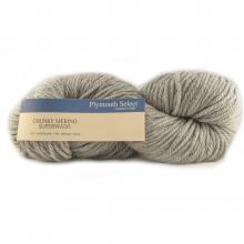 A skein of Plymouth Yacht Club Chinnacream Superwash yarn in a light oatmeal gray-beige color, with a tan paper label wrapped around it.