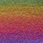 A close-up of a textured fabric or material swatch showing a smooth vertical gradient transitioning from green and yellow at the top, through orange and pink, to purple at the bottom.
