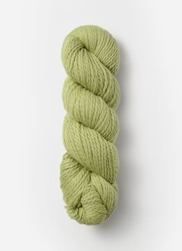 Green skein of yarn on a white background