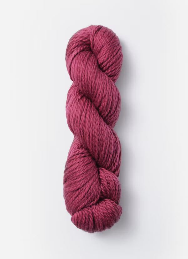 A single skein of twisted yarn in a deep berry pink or magenta shade, photographed vertically against a clean white background.