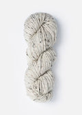 Coiled skein of yarn on a white background