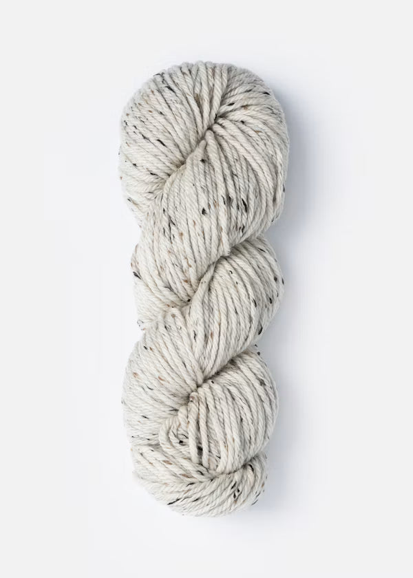 Coiled skein of yarn on a white background