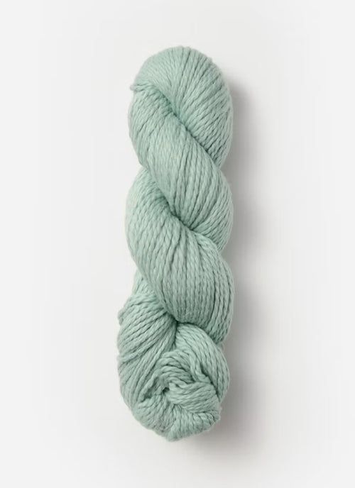 Skein of light green yarn on a white background