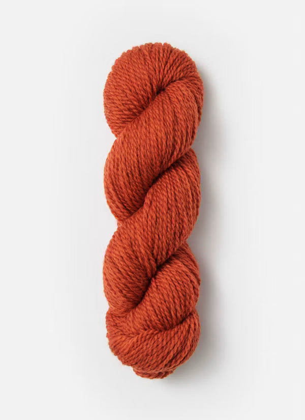 Single skein of orange yarn on a white background