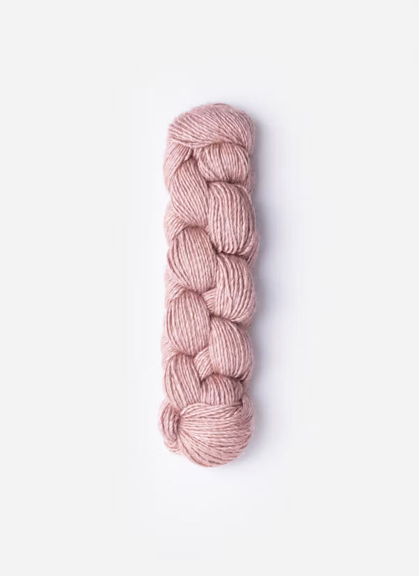 Braided pink yarn on a white background