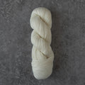 White skein of yarn on a gray textured background