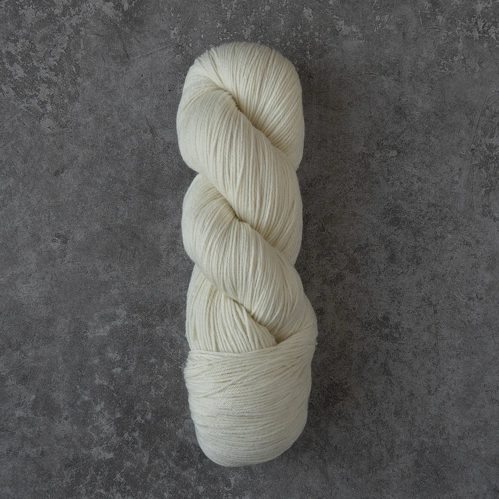 White skein of yarn on a gray textured background