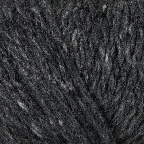 A close-up texture shot of dark charcoal gray yarn with subtle lighter gray and white flecks throughout.