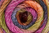 A close-up of a tightly wound skein of variegated yarn showing multiple colors including pink, orange, yellow, green, blue, and purple.