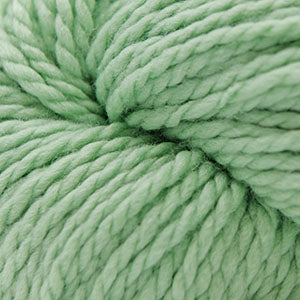 A close-up of mint green yarn wound into a skein, showing the soft, twisted texture of the fibers.