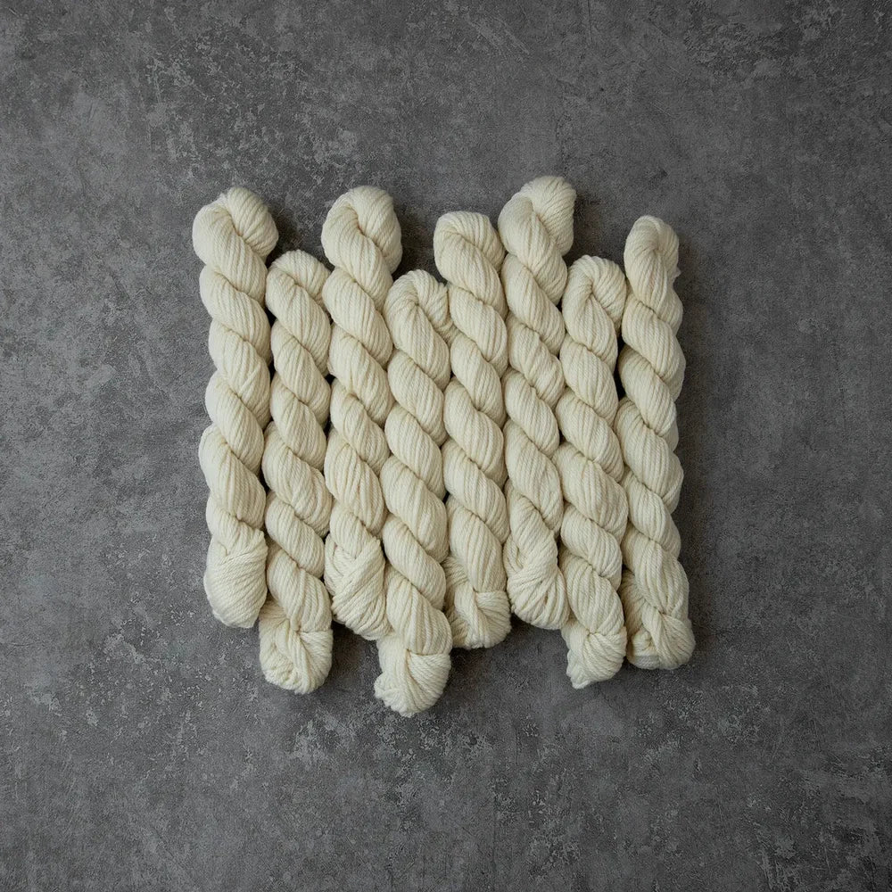 Set of braided white ropes on a gray surface