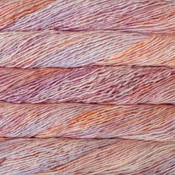 A close-up texture shot of variegated yarn strands in a blend of dusty rose, mauve, peach, and light brown.