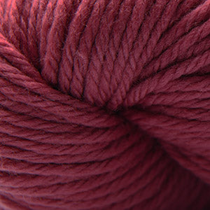 A close-up of a textured skein of yarn in a deep burgundy or maroon shade.