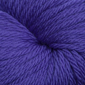 A close-up of a purple skein of yarn, showing the detailed texture of the twisted plies.