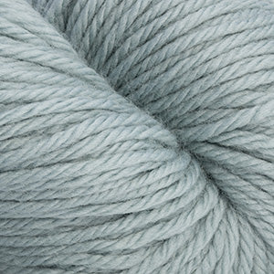 A close-up of light blue-gray plied yarn, showing the texture and color of the fibers.
