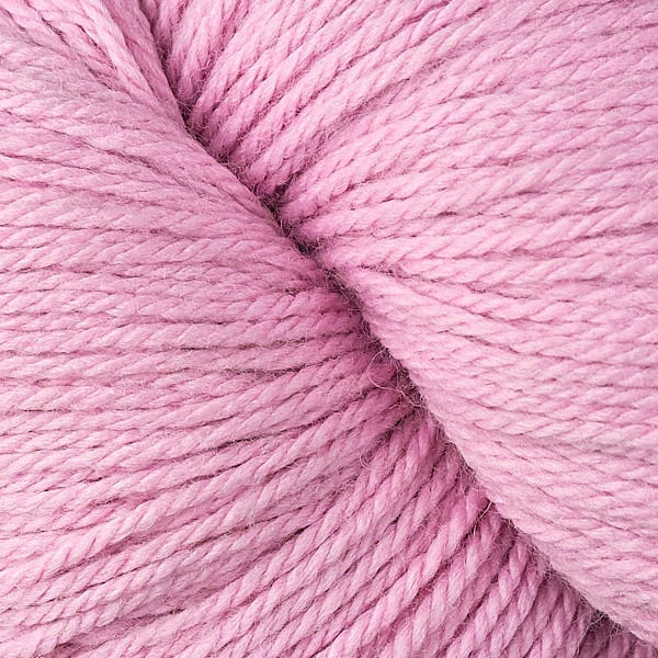 A close-up of dusty pink yarn with a soft, textured twist, filling the entire frame.
