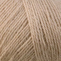 A close-up of light beige yarn with subtle shimmering fibers, filling the entire frame.
