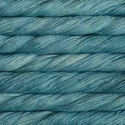 A close-up of teal blue yarn wound horizontally, showing the texture and color of the fiber.