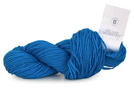 Two skeins of blue yarn with a label on a white background