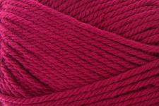A close-up of bright magenta pink yarn wound into a skein, filling the entire frame.