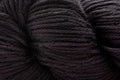 A close-up of dark charcoal gray yarn, showing the twisted plies and soft texture of the fiber.