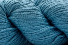 A close-up of a skein of textured yarn in a medium teal-blue color.