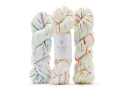 Three skeins of multicolored yarn on a white background