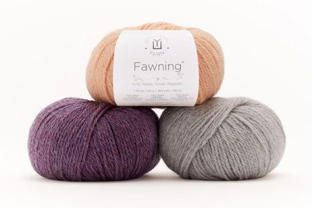 Three skeins of yarn in peach, purple, and gray with a 'Fawning' label on a white background.