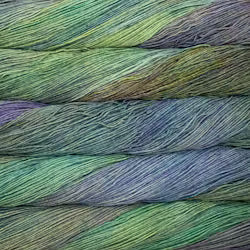 Close-up of variegated yarn strands layered horizontally, showing blended shades of green, blue, purple, and yellow.