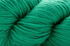 A close-up of bright teal green yarn wound into skeins, filling the entire frame.
