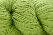 A close-up of bright lime green yarn wound into skeins, filling the entire frame.