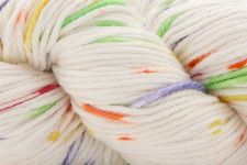 A close-up of a skein of white yarn with multicolored variegated flecks in green, orange, purple, and yellow.