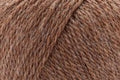 A close-up of brown yarn strands wound together, showing a heathered texture with lighter tan and slightly darker brown threads.