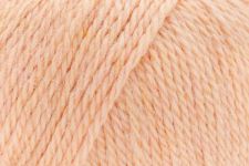 A close-up of soft peach-colored yarn strands filling the frame.