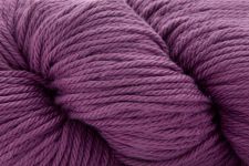 A close-up of a purple jenny bone yarn, showing the twisted plies and soft texture of the wool.