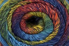 A close-up of a multicolored variegated yarn wound in a spiral pattern, showing shades of blue, yellow, orange, red, and purple.