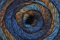 Close-up of a skein of multicolored yarn with blue, brown, and orange tones.