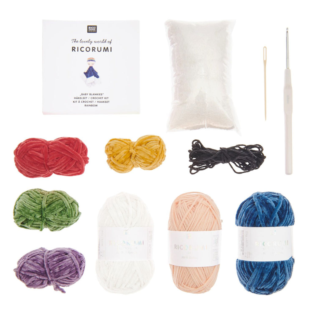 RicoRumi crochet kit featuring multiple skeins of yarn in red, yellow, black, green, white, peach, and blue, along with a white crochet hook, a wooden needle, and a white instruction booklet on a plain white background.