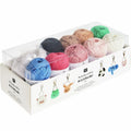 Box of colorful yarn balls with keychains on a white background