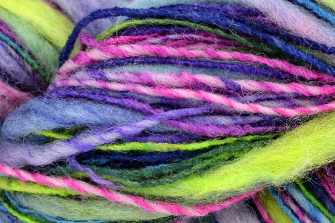 Close-up of multicolored yarn skein with purple, pink, green, and blue hues.