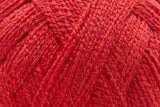 A close-up of bright red yarn strands, showing the texture and color of the fiber.