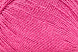 A close-up of bright pink yarn strands wound together, filling the entire frame.