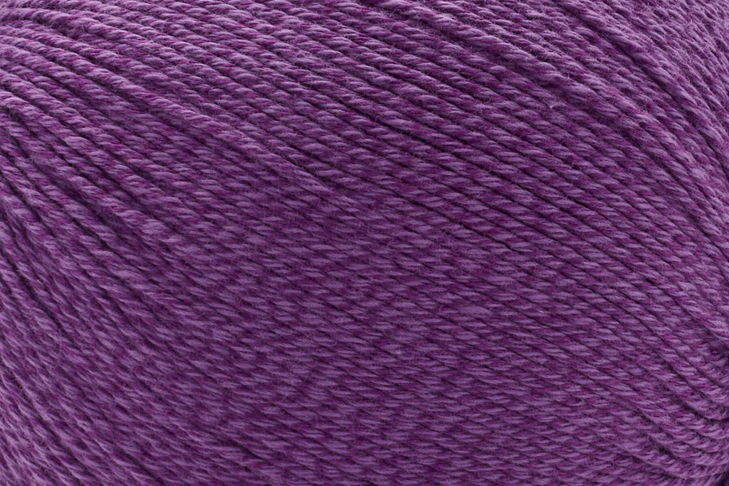 A close-up texture shot of a purple plied yarn or thread filling the entire frame.