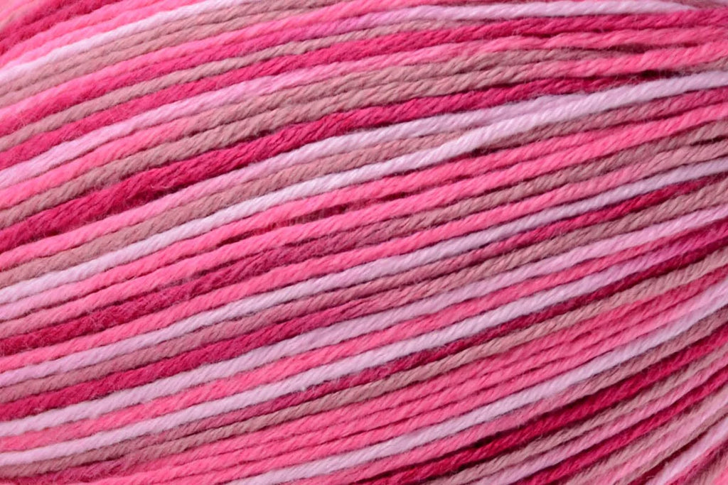 Close-up of pink and red yarn with gradient colors