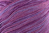 Close-up of a ball of purple yarn with multicolor strands.
