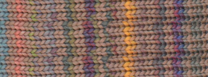 Close-up of a multicolor knit fabric with a textured chevron pattern in pastel and bright tones including pink, blue, yellow, purple, and green.