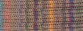 Close-up of a multicolor knit fabric with a textured chevron pattern in pastel and bright tones including pink, blue, yellow, purple, and green.